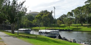 Popeye Ferries tied up for the night, with the roof of the Adelaide Oval in the background.