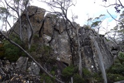 Magnificent and enormous boulders form cliffs on one side of a boulder field