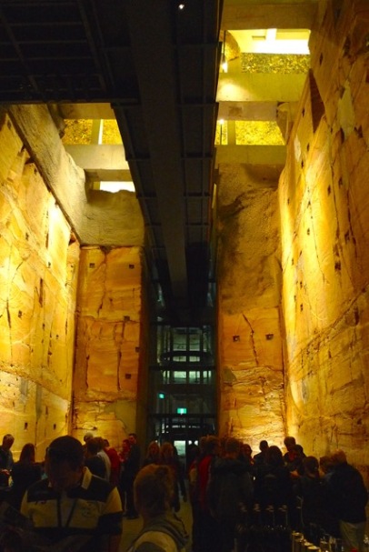 MONA's subterranean entrance-exit from the Void Bar, showing off the Jurassic sandstone, raw-finish commercial construction, and the glass elevator