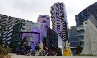 Bromptons with artwork in front of buildings at Docklands - all very colourful (photo by Elsie)