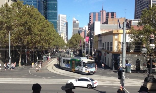 A Melbourne B-Class Tram (Route 86) turning at top of Bourke Street onto Spring Street in front of Parliament House