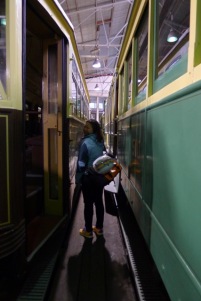 Elsie walking between trams